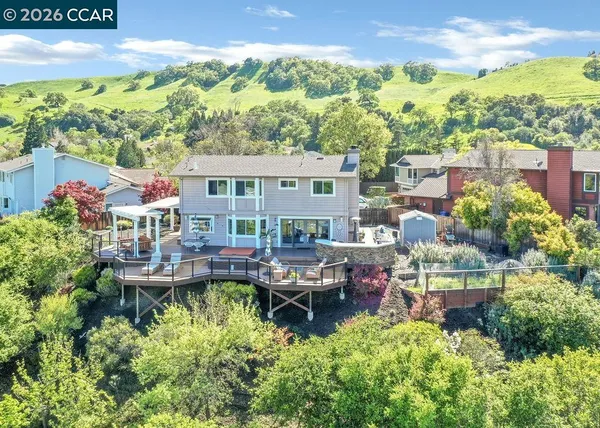 a front view of a house with swimming pool garden and outdoor seating