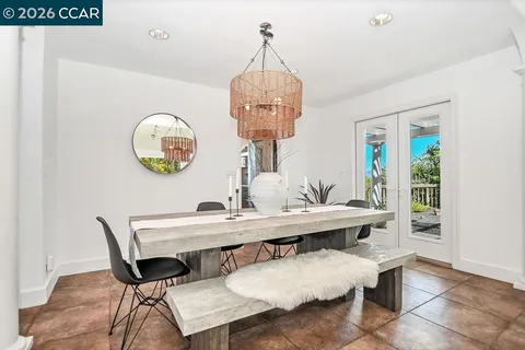 a view of a dining room with a table and chairs