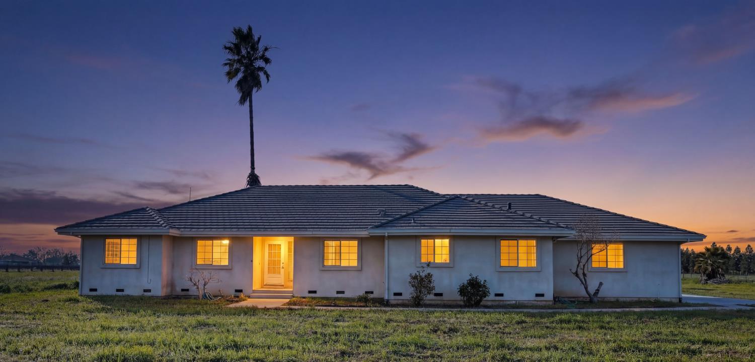 a front view of a house with a yard and a garage