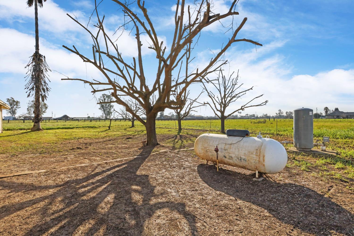 24257 North Pearl Road Acampo, CA 95220 - Photo 12 of 41 a white house with a yard and outdoor seating