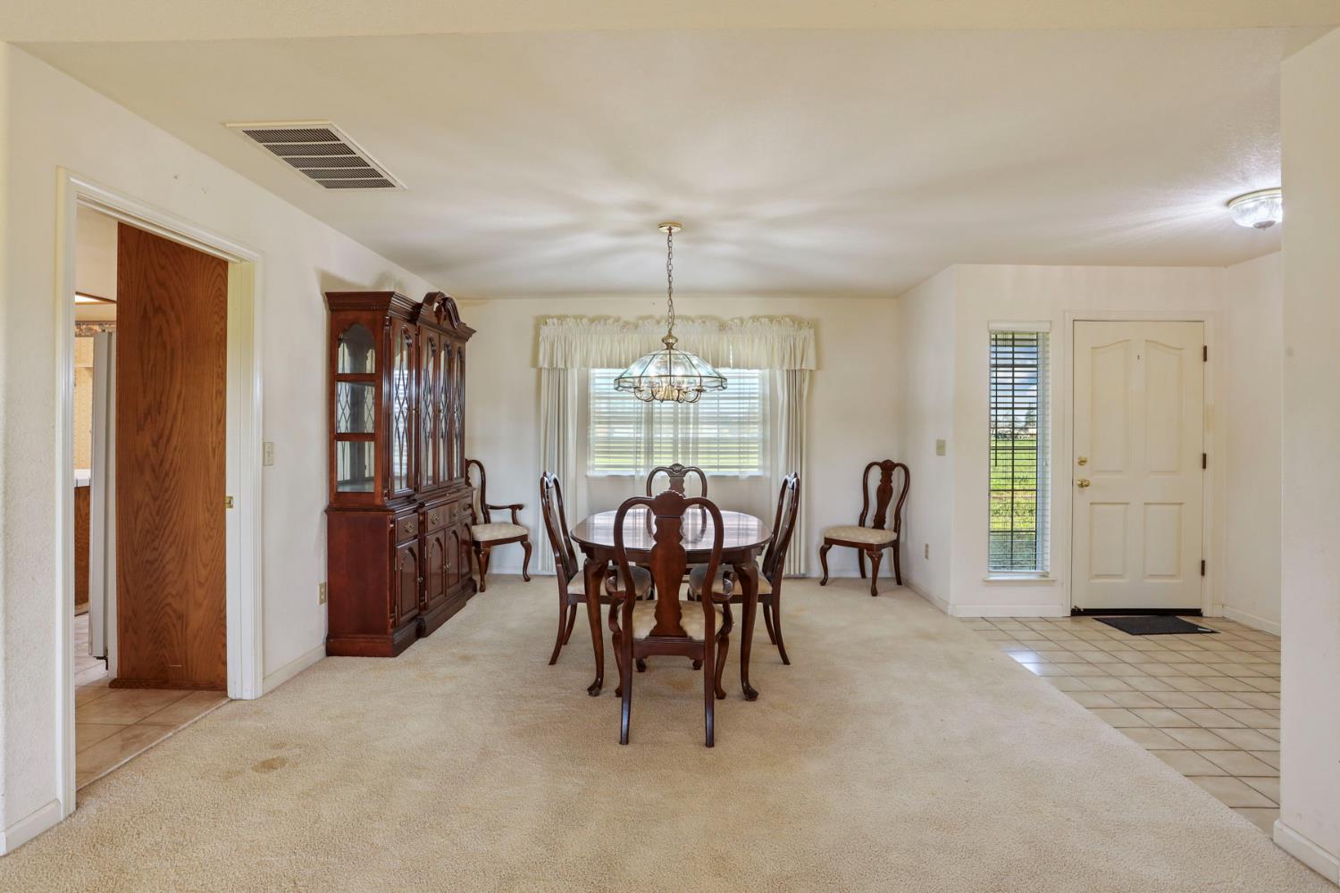 24257 North Pearl Road Acampo, CA 95220 - Photo 18 of 41 a view of a dining room with furniture and window