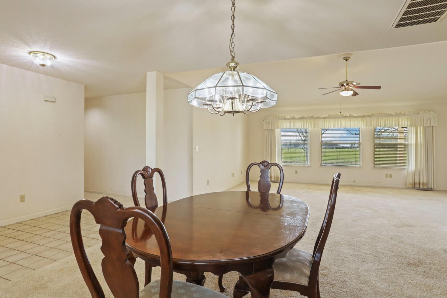 24257 North Pearl Road Acampo, CA 95220 - Photo 20 of 41 a dining room with furniture and chandelier