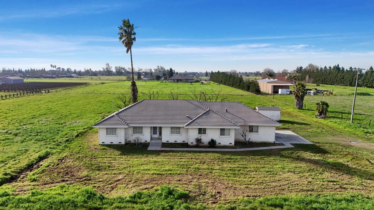 24257 North Pearl Road Acampo, CA 95220 - Photo 2 of 41 a aerial view of a house with swimming pool and a yard