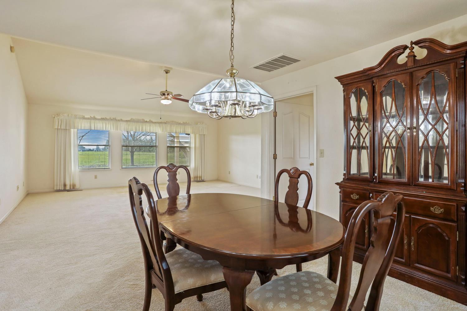 24257 North Pearl Road Acampo, CA 95220 - Photo 21 of 41 a dining room with furniture a chandelier and window