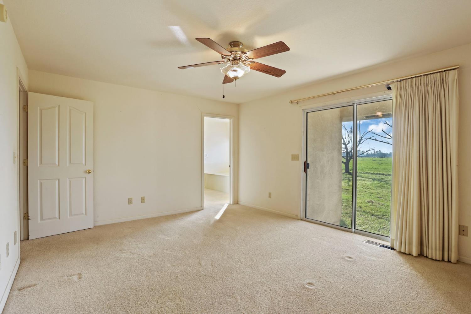24257 North Pearl Road Acampo, CA 95220 - Photo 23 of 41 a view of an empty room with a ceiling fan