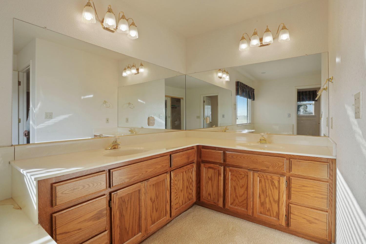 24257 North Pearl Road Acampo, CA 95220 - Photo 25 of 41 a bathroom with a sink vanity and a mirror