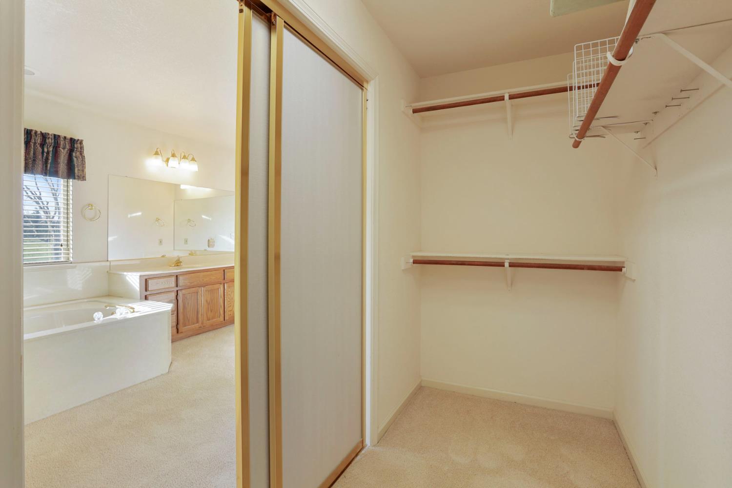 24257 North Pearl Road Acampo, CA 95220 - Photo 28 of 41 a bathroom with a bathtub and a shower