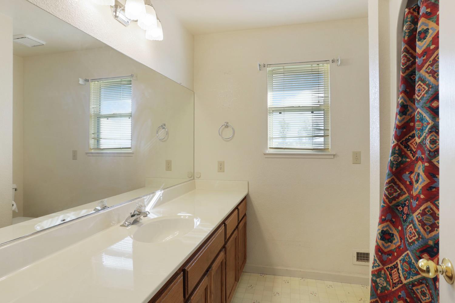 24257 North Pearl Road Acampo, CA 95220 - Photo 41 of 41 a bathroom with a sink a vanity and a mirror