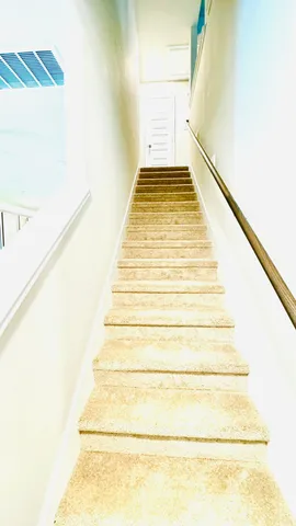 a view of a room with wooden floor and staircase