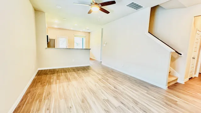 a view of a room with wooden floor and a window