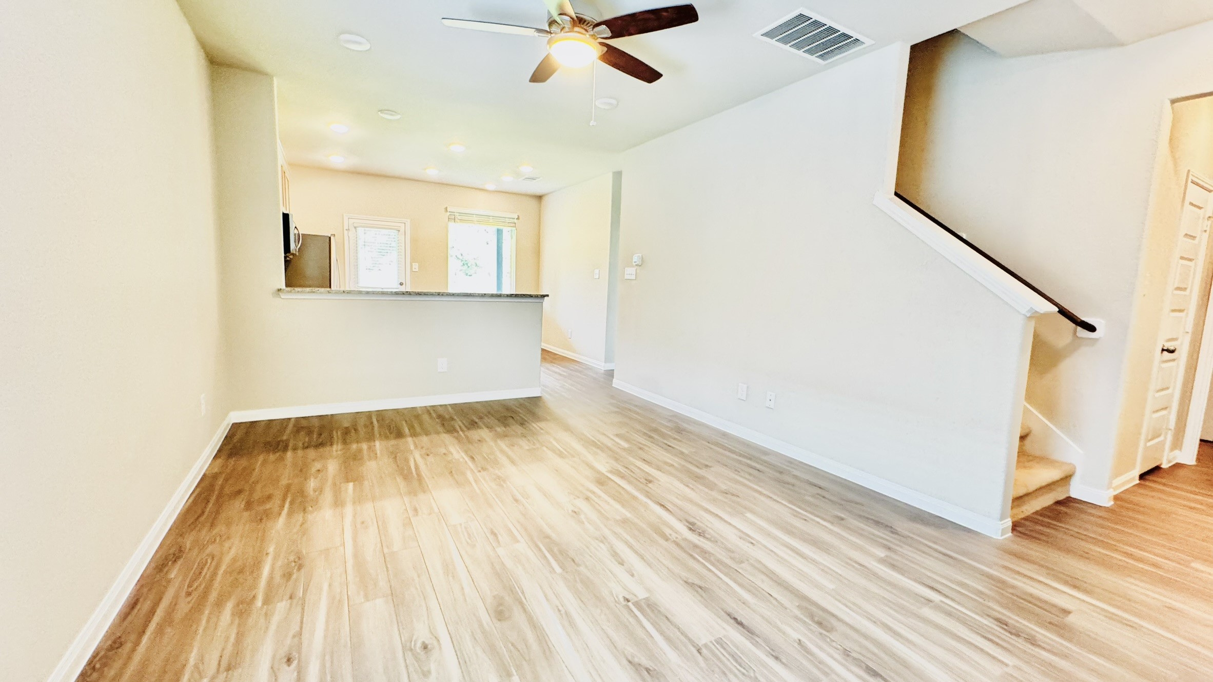 2423 Bluefish Court Conroe, TX 77384 - Photo 14 of 30 a view of a room with wooden floor and staircase
