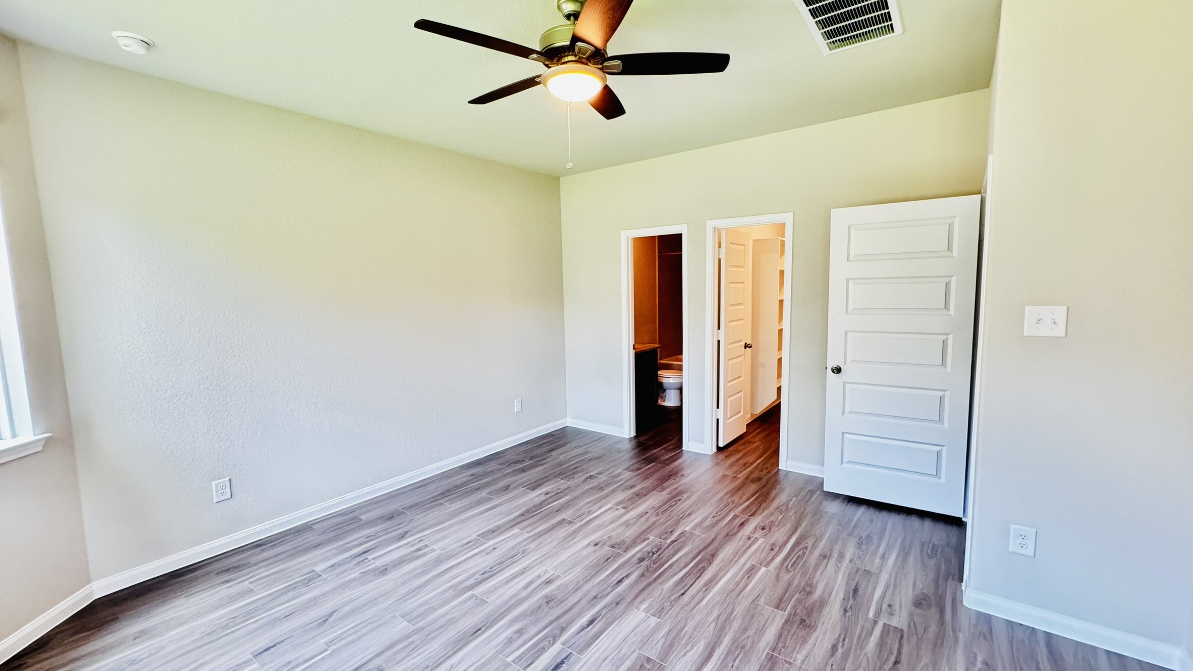 2423 Bluefish Court Conroe, TX 77384 - Photo 16 of 30 an empty room with wooden floor closet and windows