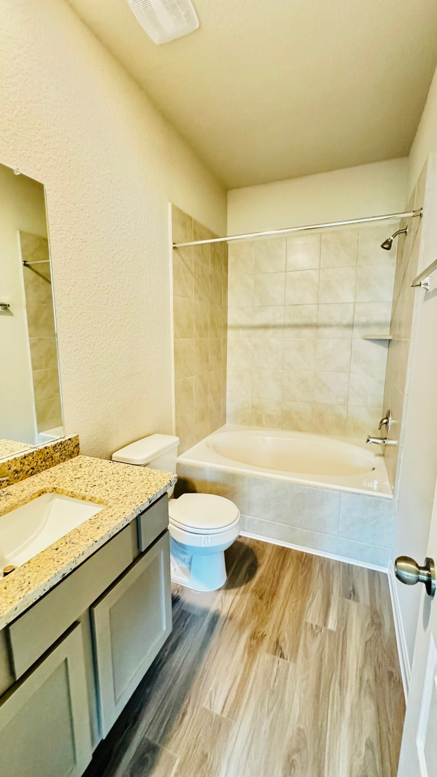 2423 Bluefish Court Conroe, TX 77384 - Photo 18 of 30 a bathroom with a granite countertop sink toilet and bathtub