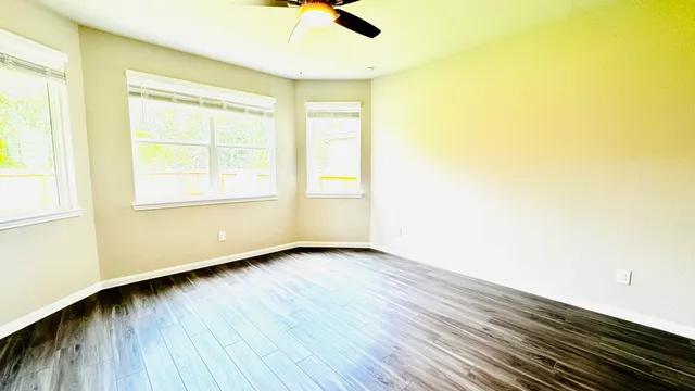 a view of a kitchen with wooden floor and a sink
