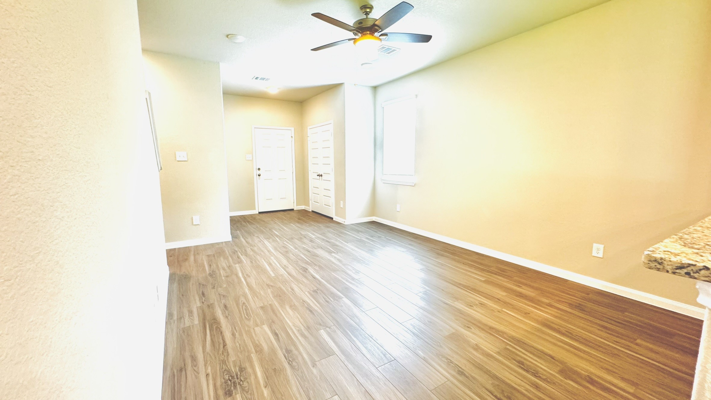 2423 Bluefish Court Conroe, TX 77384 - Photo 22 of 30 a view of a room with wooden floor and a ceiling fan