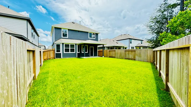 a view of a house with a yard and sitting area