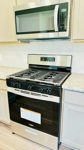 a stove top oven sitting inside of a kitchen