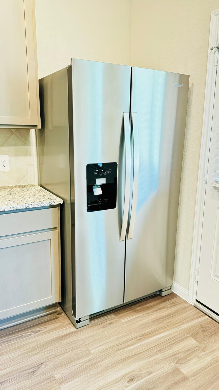 2423 Bluefish Court Conroe, TX 77384 - Photo 6 of 30 a view of a refrigerator in kitchen with stainless steel appliances wooden floor
