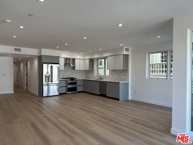 a view of kitchen with stainless steel appliances refrigerator and microwave