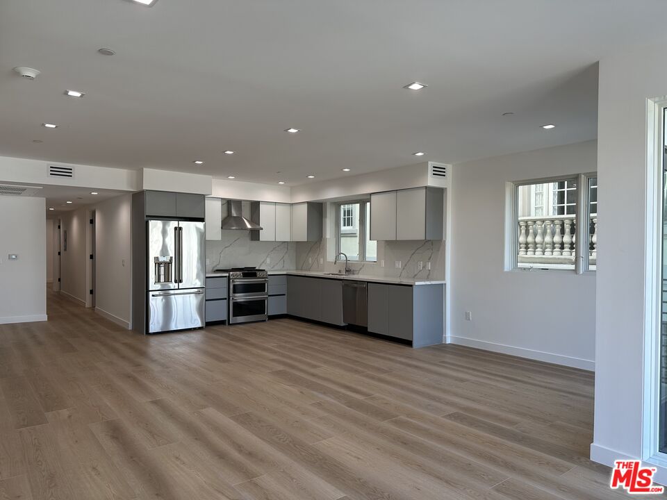 a view of kitchen with stainless steel appliances refrigerator and microwave