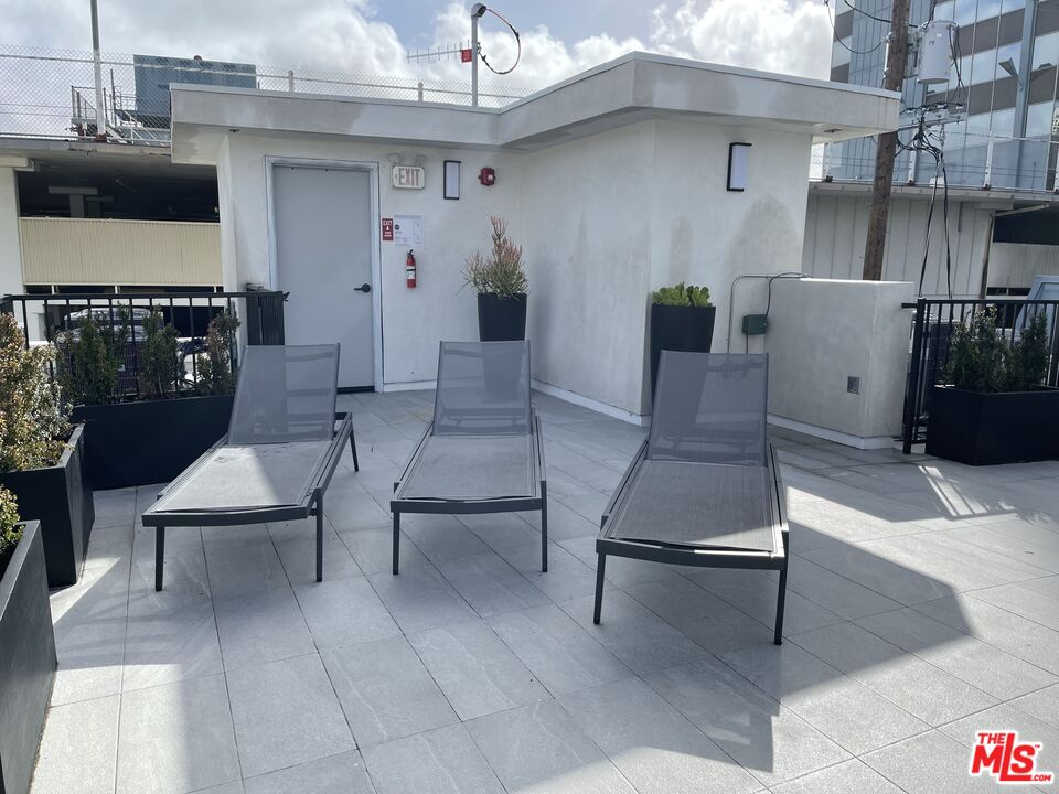 9842 Vidor Drive, Unit 201 Los Angeles, CA 90035 - Photo 17 of 20 a living room with furniture and a chandelier