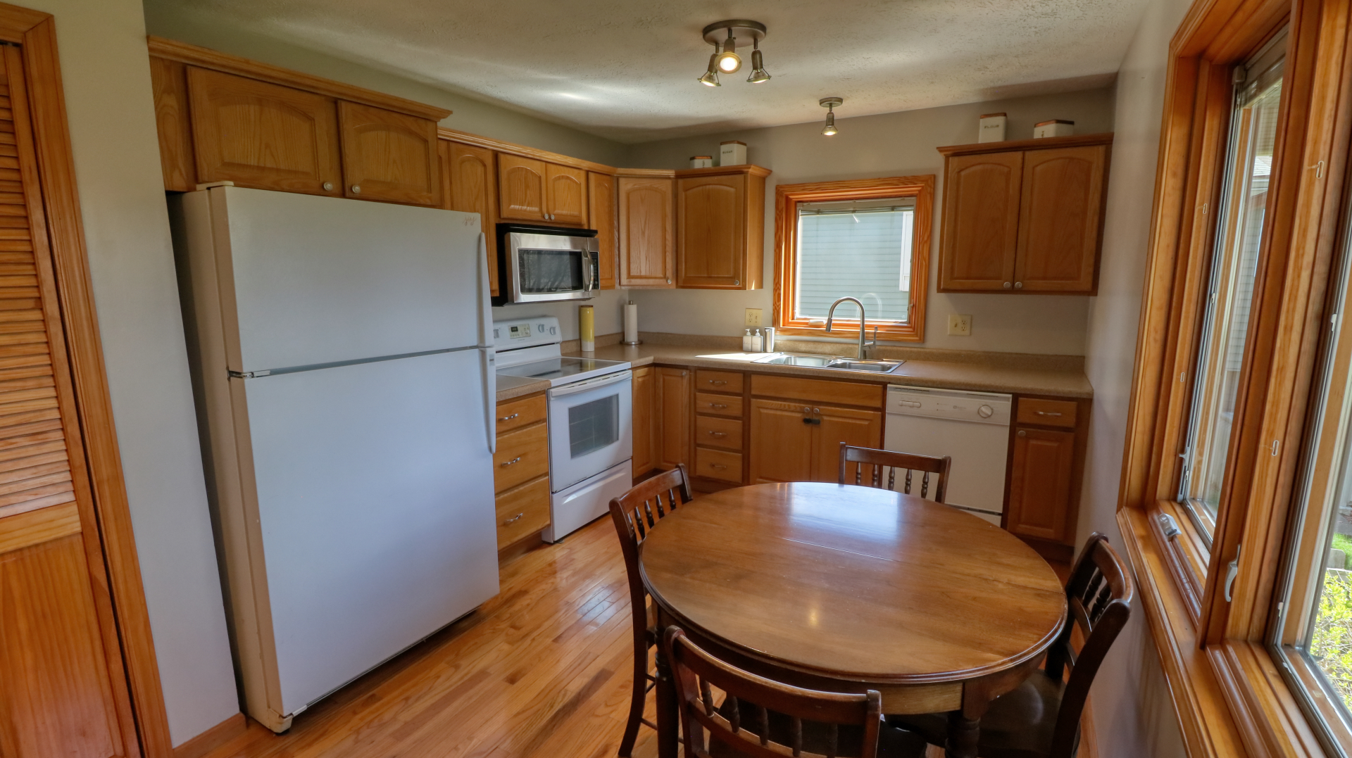 23 Cedar Court Bloomington, IL 61701 - Photo 11 of 36 a kitchen with stainless steel appliances a refrigerator a sink a stove a dining table and chairs