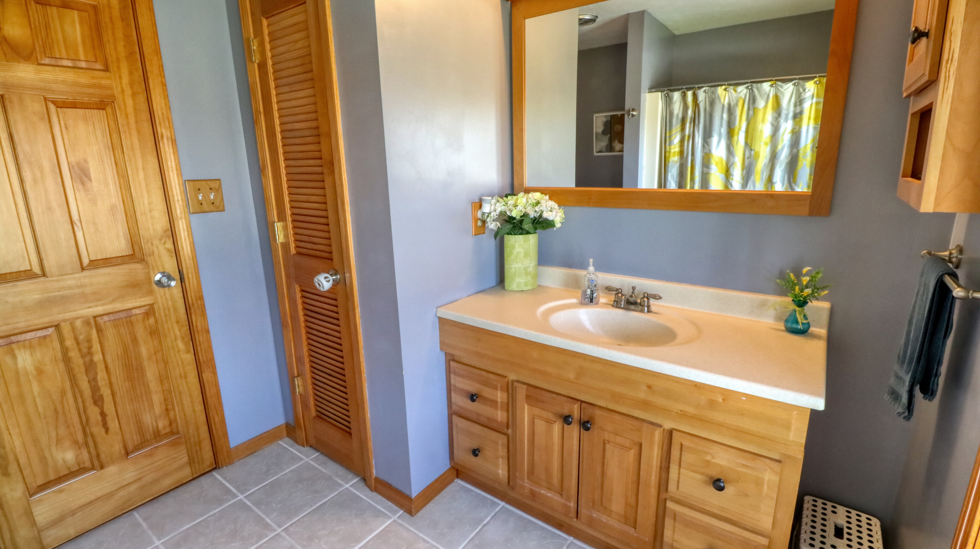 23 Cedar Court Bloomington, IL 61701 - Photo 12 of 36 a bathroom with a sink a mirror and a shower