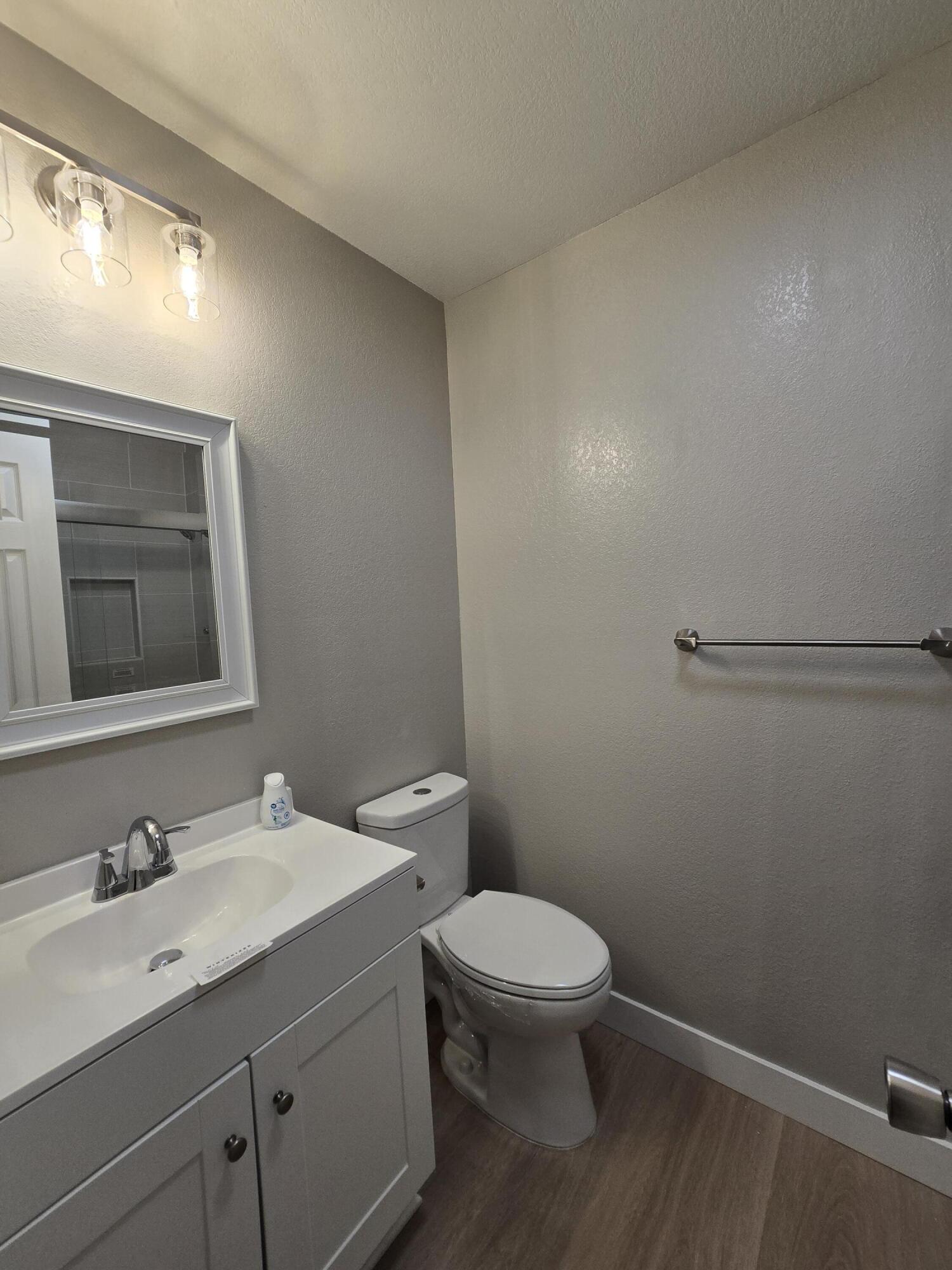 8353 Starlite Pines Road Shingletown, CA 96088 - Photo 13 of 30 a bathroom with a granite countertop sink mirror vanity and toilet