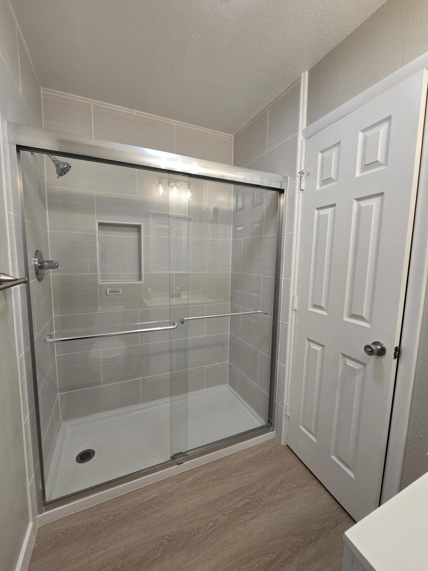 8353 Starlite Pines Road Shingletown, CA 96088 - Photo 14 of 30 a bathroom with a glass door shower