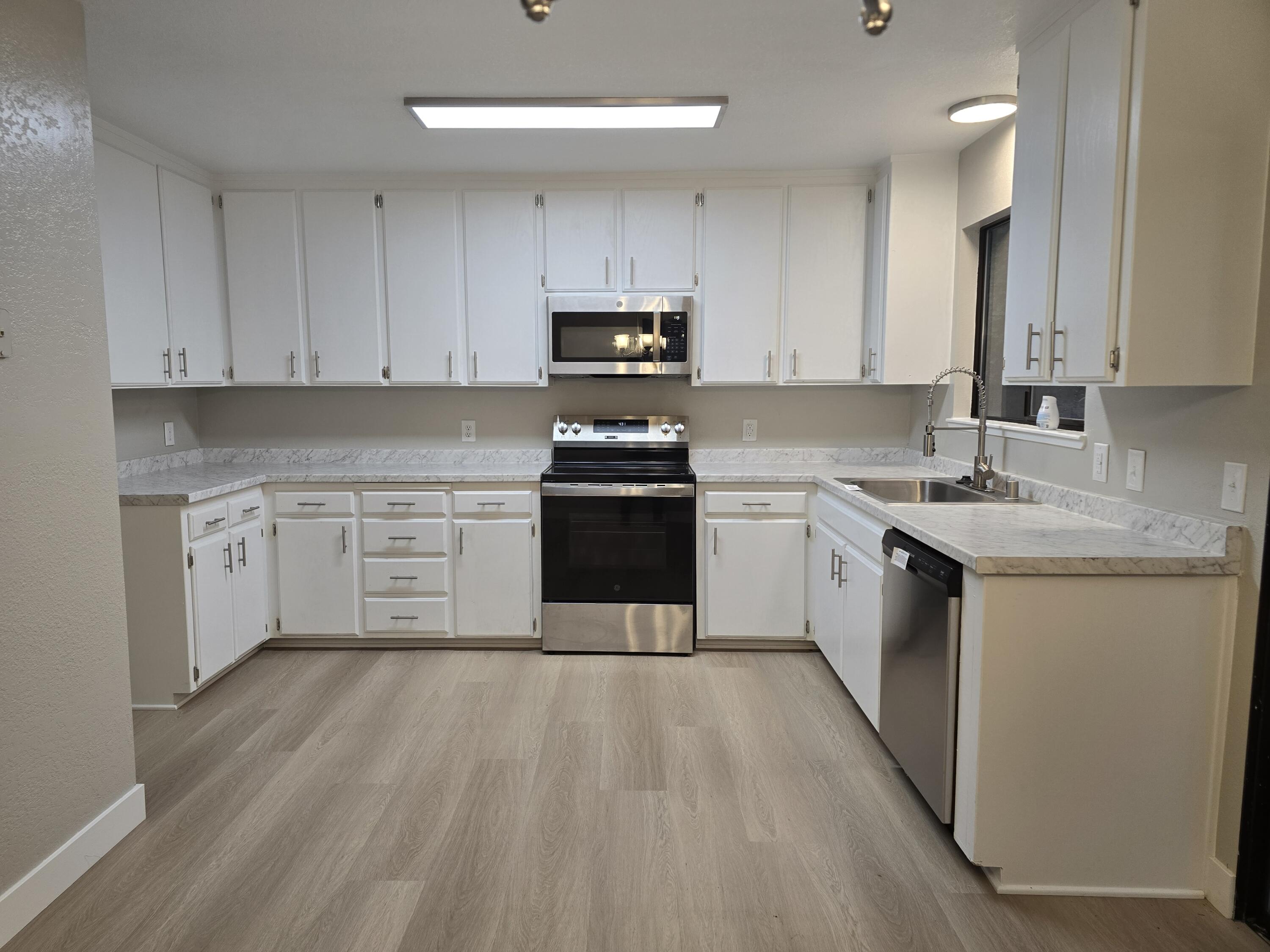 8353 Starlite Pines Road Shingletown, CA 96088 - Photo 2 of 30 a kitchen with a sink a stove and cabinets