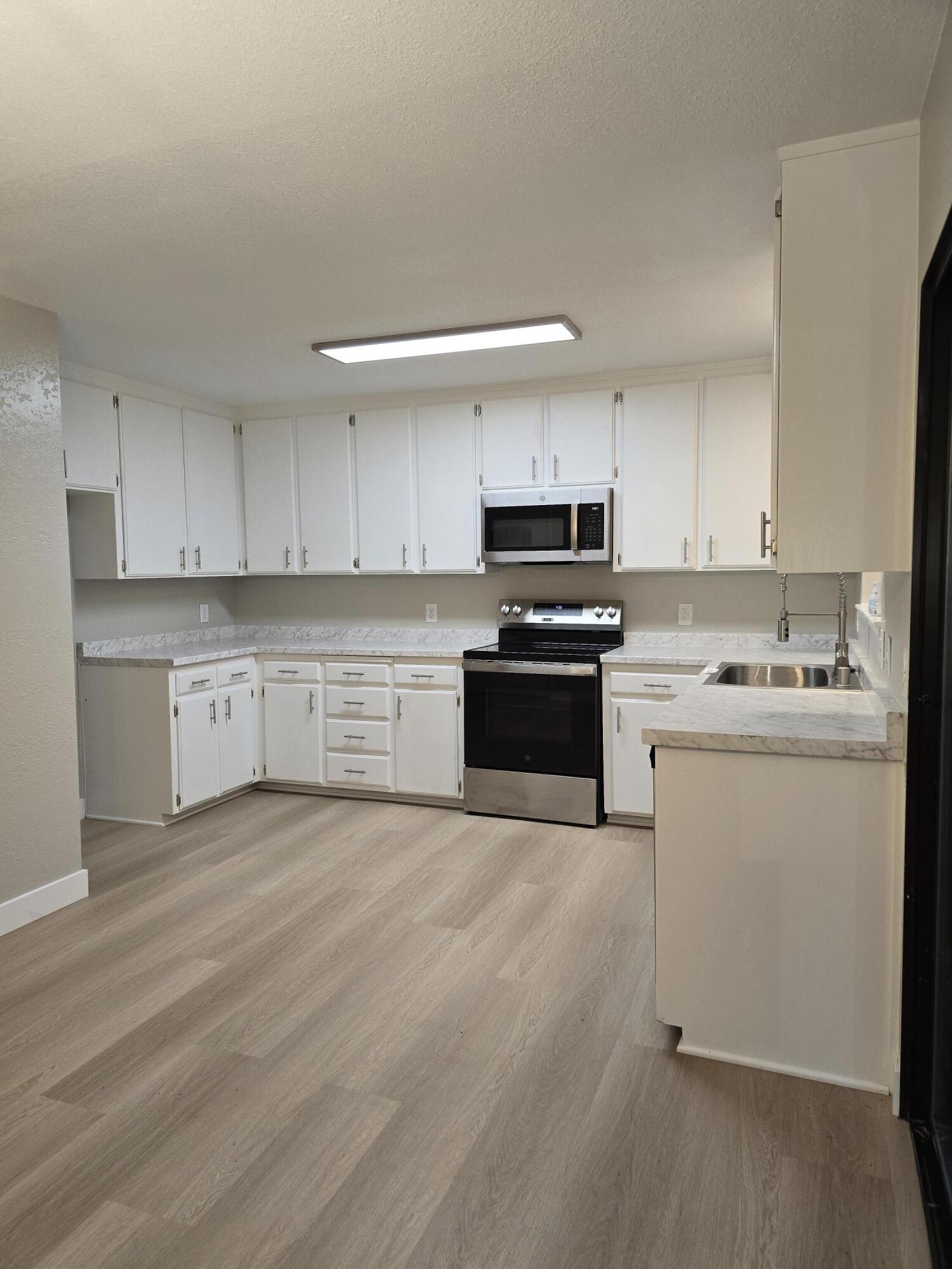 8353 Starlite Pines Road Shingletown, CA 96088 - Photo 3 of 30 a kitchen with cabinets stainless steel appliances and a sink