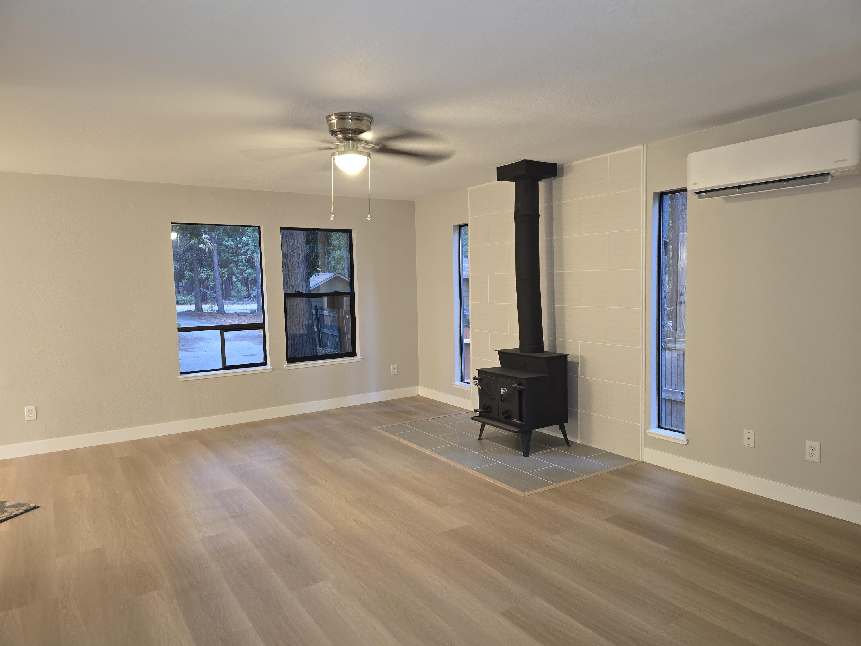 8353 Starlite Pines Road Shingletown, CA 96088 - Photo 5 of 30 a living room with hardwood floor and a ceiling fan
