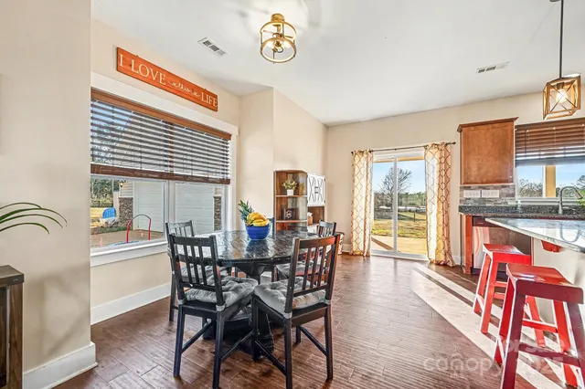 a dining room with furniture and wooden floor