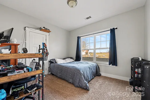 a bedroom with two beds and a window