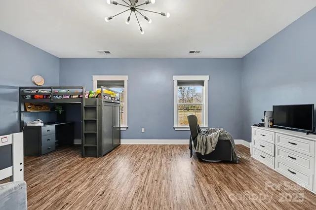 a bedroom with furniture and a window