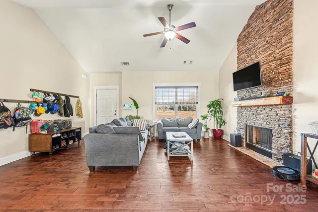 a living room with furniture a fireplace and a flat screen tv