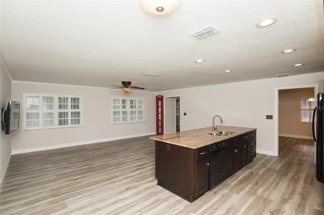 a bathroom with a granite countertop sink a mirror and a shower
