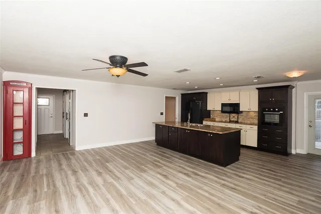 a view of kitchen with sink microwave and refrigerator