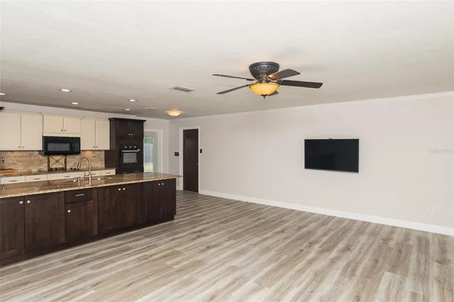 a view of kitchen with wooden floor and window