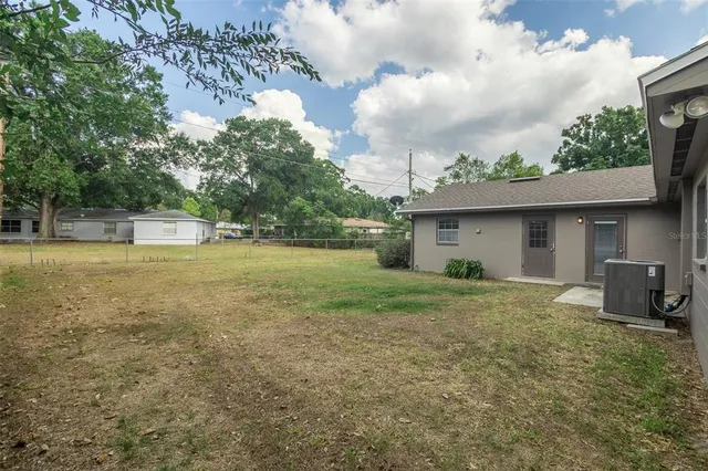 a view of a house with a yard and sitting area