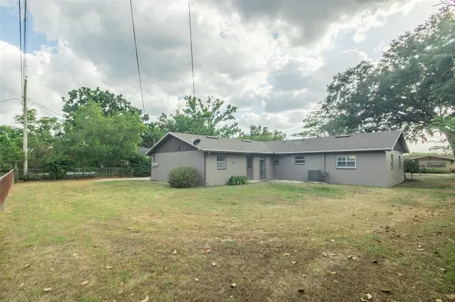 a view of a house with a yard and garage