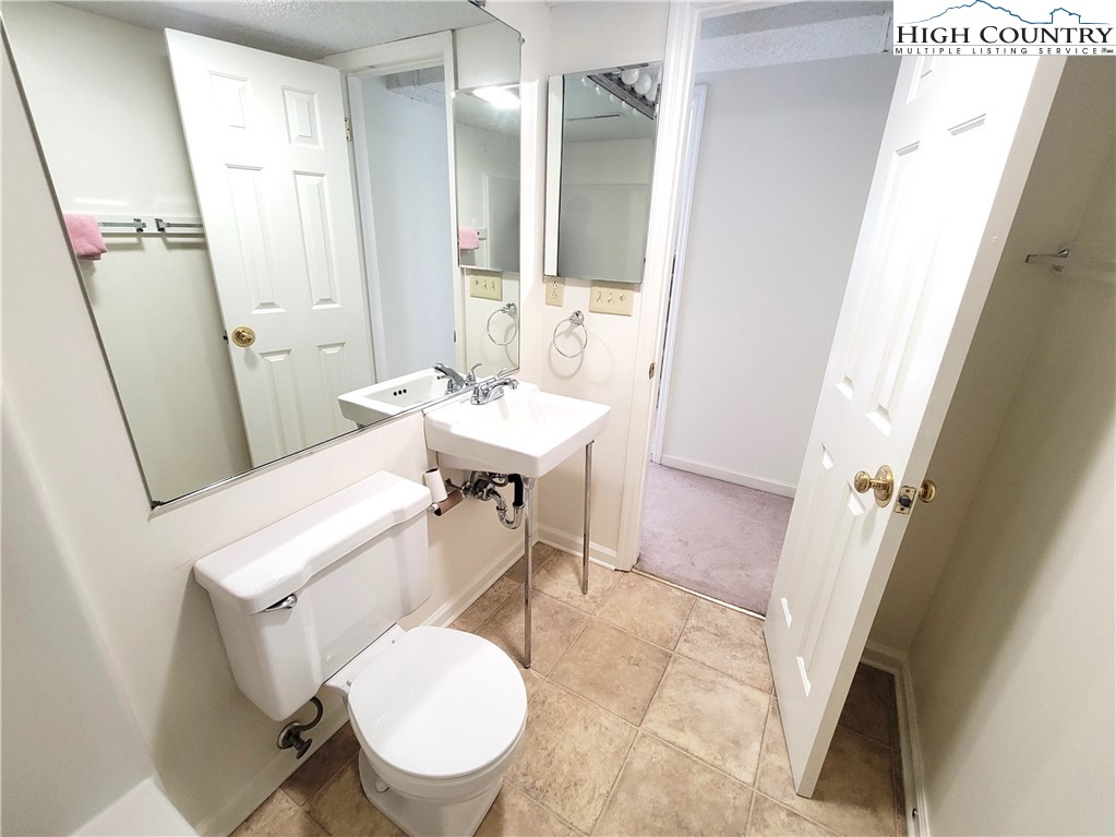 139 Wey Street Boone, NC 28607 - Photo 16 of 25 a bathroom with a sink a toilet a mirror and a tub