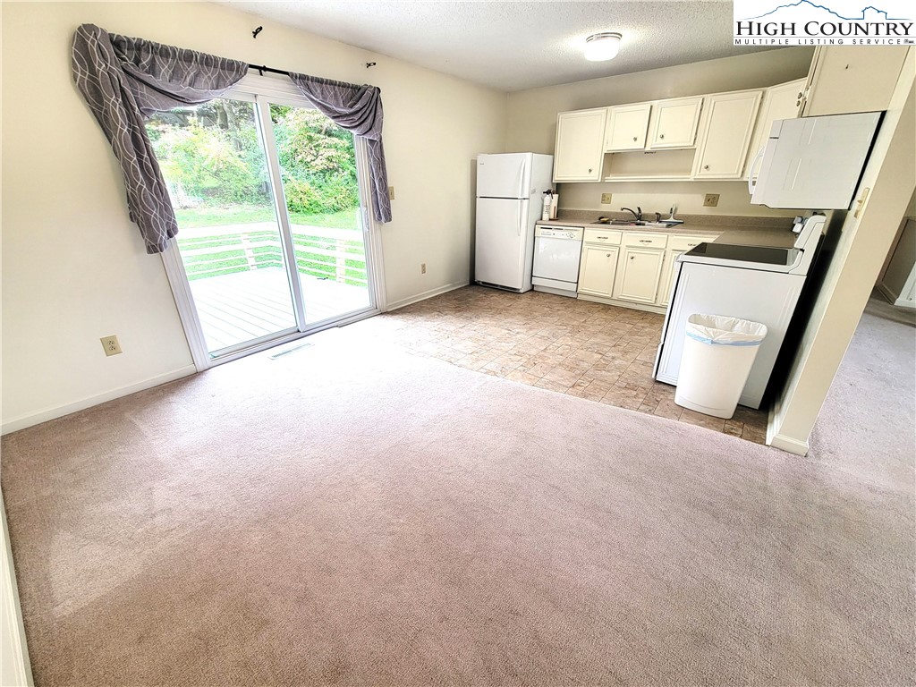 139 Wey Street Boone, NC 28607 - Photo 8 of 25 a view of kitchen with stainless steel appliances wooden floor and window