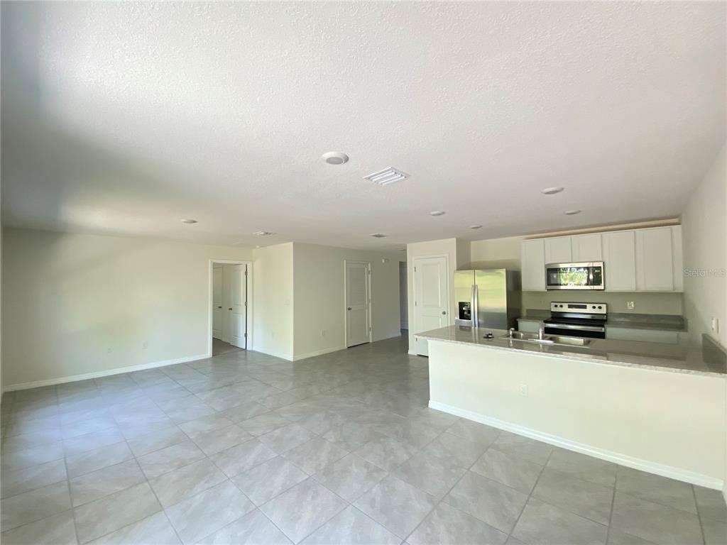 492 Hickory Course Loop Ocala, FL 34472 - Photo 4 of 28 a view of a kitchen with a sink and a stove top oven