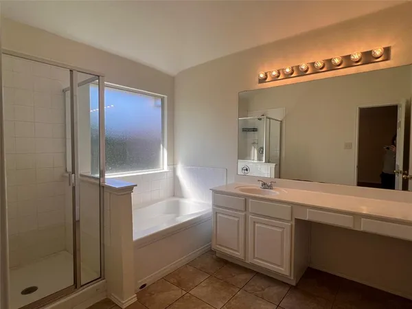a bathroom with a double vanity sink a mirror and shower