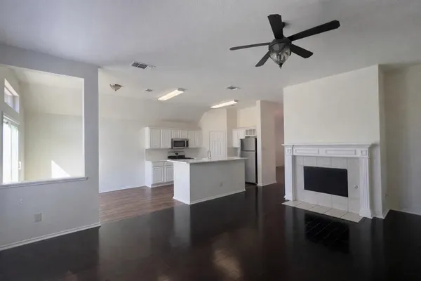 a view of a kitchen with a stove wooden floor and a window
