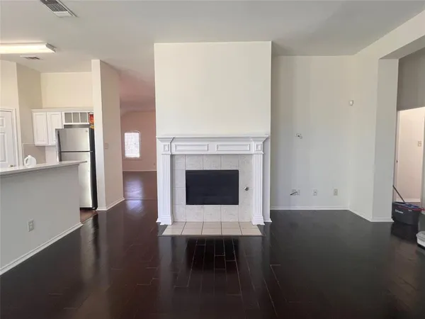 a living room with a fireplace windows and a table