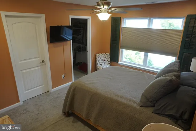 a bedroom with a bed and a flat tv screen