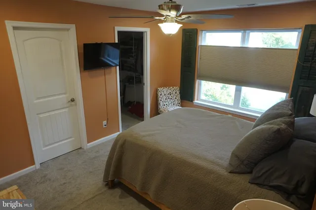 a bedroom with a bed and a mirror