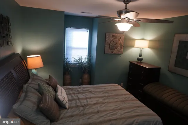 a bedroom with a bed and a lamp